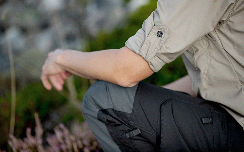 Close up image of Torraka work trousers and work shirt in a nature environment